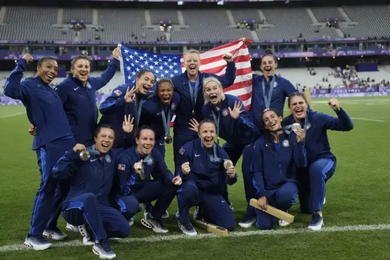 Historic Bronze for US Women’s Rugby Sevens at 2024 Paris Olympics with Last-Minute Win Historic Bronze for US Women’s Rugby Sevens at 2024 Paris Olympics with Last-Minute Win The U.S. women’s rugby sevens team made history at the 2024 Paris Olympics by clinching their first-ever Olympic medal with a thrilling 14-12 victory over Australia in the bronze medal match. Final Moments Drama In a match that kept fans on the edge of their seats, Alex Sedrick emerged as the hero. With mere seconds remaining, Sedrick sprinted down the field to score a try and then successfully converted the kick, securing a 14-12 win for Team USA. This exhilarating finish clinched the U.S. its first Olympic medal in rugby sevens and marked a significant breakthrough for American rugby. Match Highlights Australia Takes an Early Advantage: The match kicked off with immediate impact as Maddison Levi put Australia ahead with a try just over a minute into play. U.S. Equalizes: Team USA responded with a try from Alev Kelter and a conversion, leveling the score at 7-7 by halftime. Australia’s Brief Advantage: In the second half, Maddison Levi and her sister Teagan combined for another try, pushing Australia ahead 12-7. Sedrick’s Heroic Play: Sedrick’s decisive breakaway try and conversion in the final moments sealed the victory for the U.S. Player Spotlight Alex Sedrick, a Salt Lake City native, was instrumental in the win. Despite not being the regular kicker, Sedrick stepped up to make the crucial conversion. Reflecting on the experience, Sedrick said, “It’s okay to be nervous, it’s okay to doubt yourself, but as long as the next action is toward your goal, it’s going to work out.” Team Performance Before competing in the bronze medal match, the U.S. had encountered a significant hurdle, falling to the defending champions, New Zealand. Nonetheless, their grit and resolve were evident in their performance against Australia. The Australians, having also lost to Canada in the semifinals, were unable to secure their second Olympic medal. Emotional Celebration The victory was a moment of joy and pride for the U.S. team. Captain Ilona Maher, alongside her teammates, was visibly emotional during the medal ceremony, reflecting on the significance of the achievement. Maher praised Sedrick’s performance and highlighted the collective effort of the team throughout the tournament. Looking Ahead This historic bronze medal not only highlights the rising profile of U.S. rugby sevens but also sets a new standard for the sport in America. The team’s performance in Paris is a testament to their hard work and determination, paving the way for future successes in international rugby. Stay tuned for more updates and highlights from the 2024 Paris Olympics and other major sporting events.