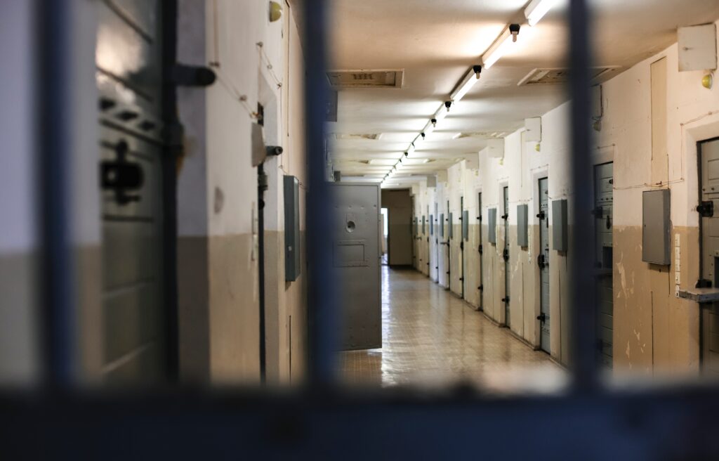 Illustrative photo: a prison corridor where a detainee stained the peephole of her cell with her excrement.